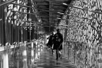 People walking on bridge in city