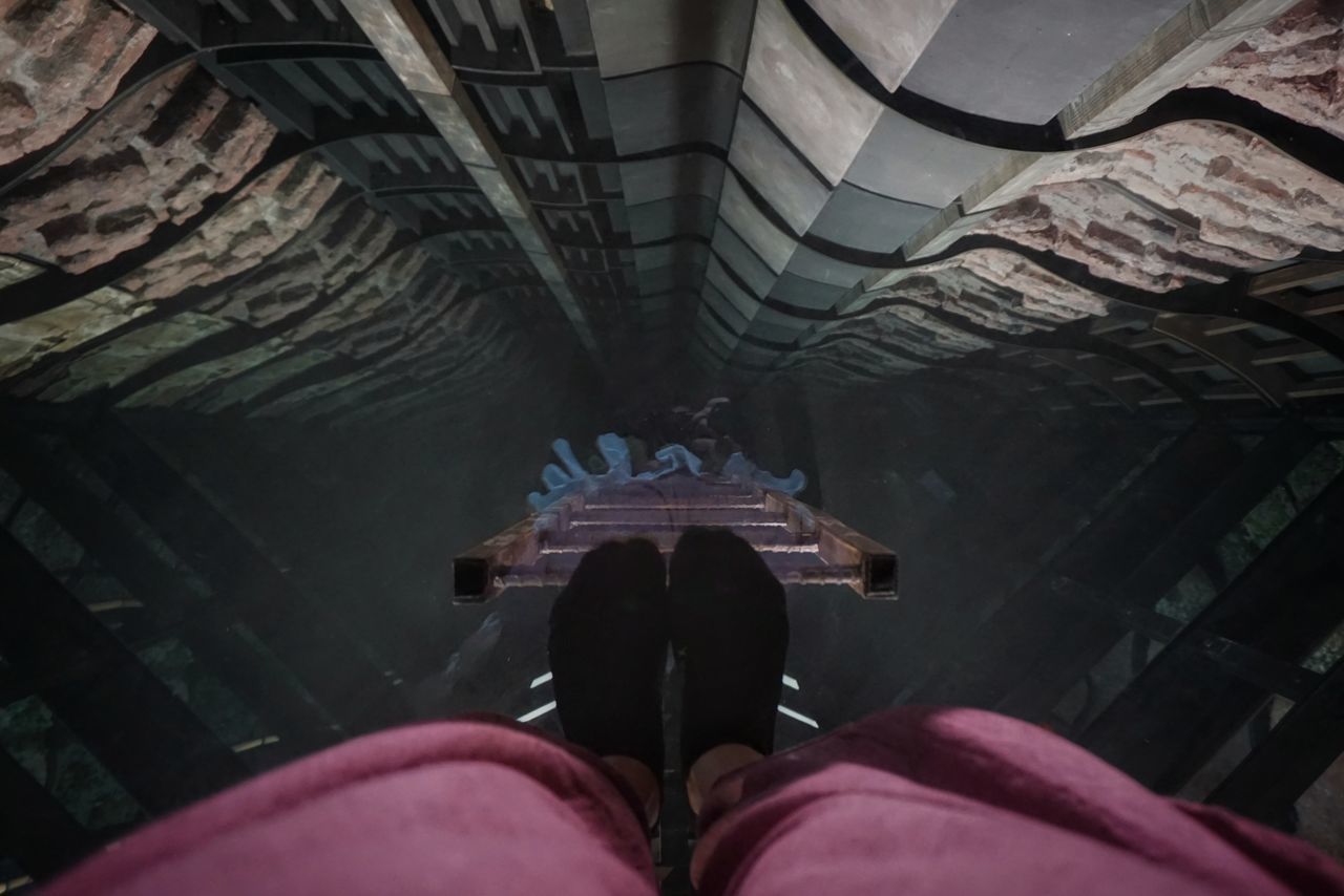 LOW SECTION OF WOMAN STANDING ON CEILING