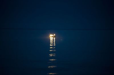 Scenic view of sea against clear sky at night