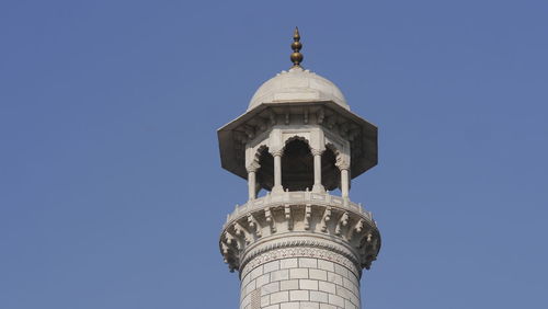 Low angle view of bell tower against blue sky