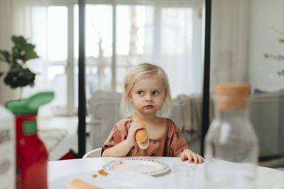 Girl eating hot dog