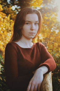 Portrait of young woman looking away outdoors