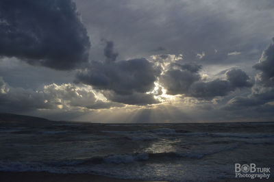 Scenic view of sea against storm clouds