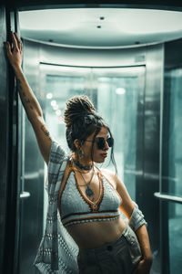 Portrait of young woman wearing sunglasses standing outdoors