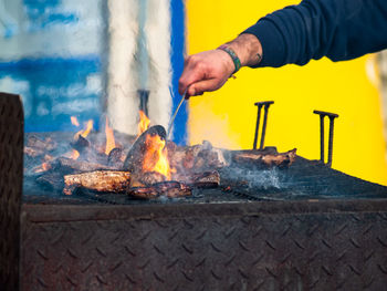 Man preparing food on barbecue grill