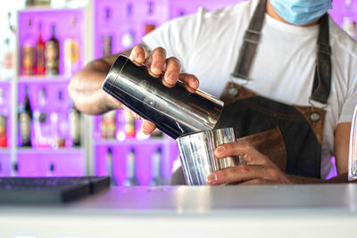 Midsection of man preparing food in kitchen