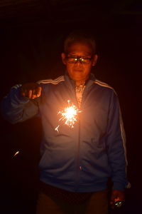 Young man standing at night