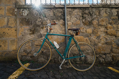 Bicycle parked against wall