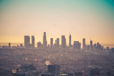 Cityscape against sky during sunset