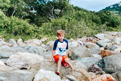 Portrait of boy standing on rock