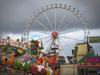 Low angle view of ferris wheel against sky