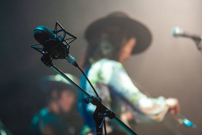 Rear view of man photographing at music concert