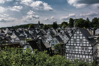 Panoramic view of trees and buildings against sky