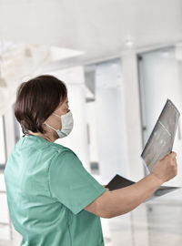 Side view of woman looking at camera