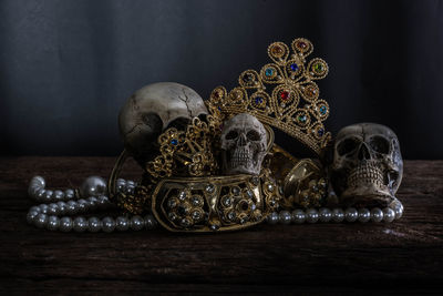 Close-up of jewelry and human skull on table 