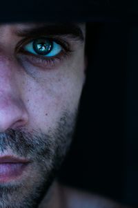 Cropped image of serious man with green eyes