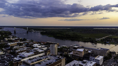 High angle view of buildings by sea against sky