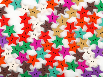 Full frame shot of colorful star shaped decorations against white background