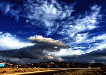 Scenic view of landscape against cloudy sky