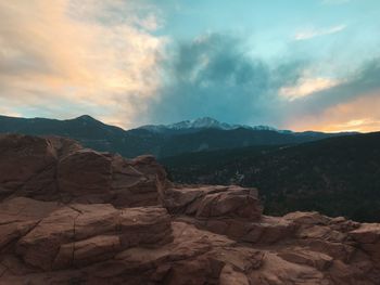 Scenic view of mountains against cloudy sky