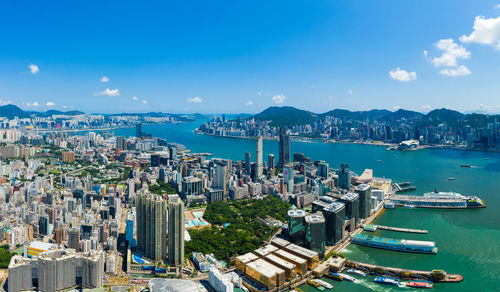 High angle view of bay and buildings against blue sky