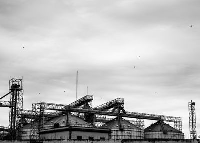 Low angle view of factory against sky