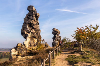 Old sculpture on land against sky