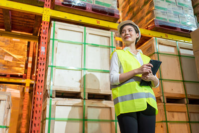 Low angle view of woman using mobile phone