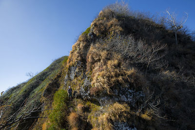 Low angle view of rock formation against sky