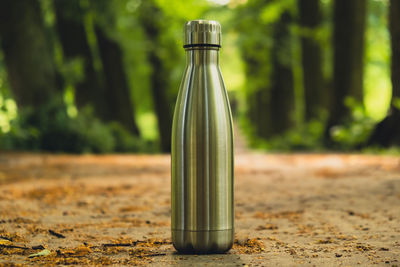 Water bottle. reusable steel thermo water bottle on green grass. sustainable lifestyle. plastic free