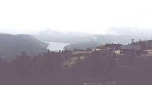 Houses on mountain against sky