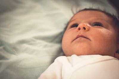 Close-up of baby sleeping on bed