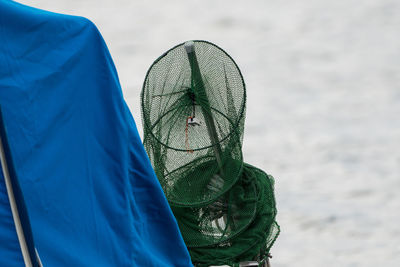 Close-up of fishing net against sky