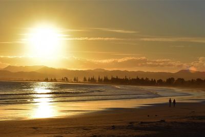 Scenic view of beach against sky during sunset