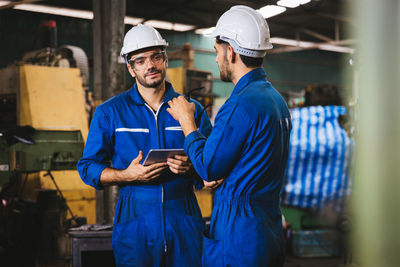 Portrait of man standing in factory