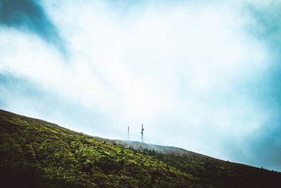 Low angle view of hill against sky