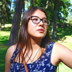Close-up of young woman wearing sunglasses at park