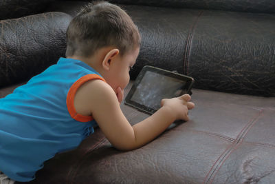 High angle view of boy using mobile phone