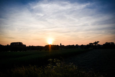 Scenic view of field against sky during sunset