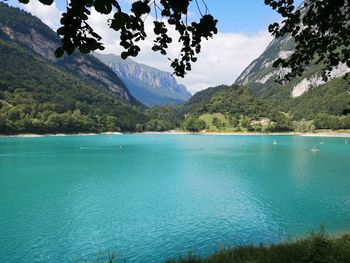 Scenic view of sea and mountains against sky