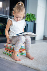 Portrait of cute girl sitting on chair