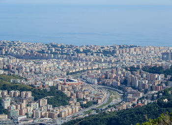 High angle view of townscape by sea against sky