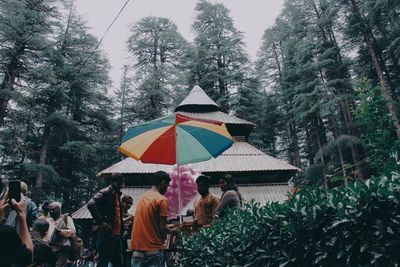 Group of people on umbrella during rainy season