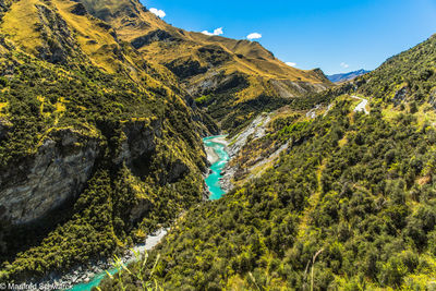 Scenic view of mountains against blue sky