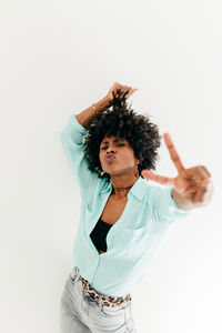 Young woman standing against white background