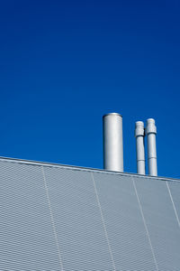 Low angle view of smoke stack against sky