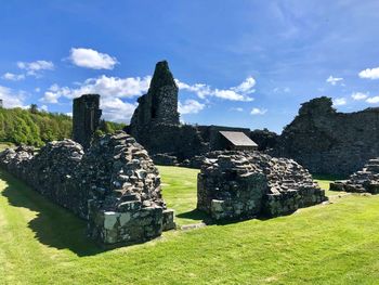 Stone structure on field against sky