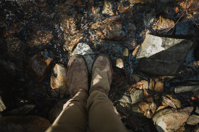 Low section of man standing on rock