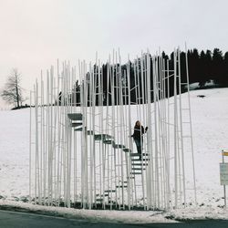 Man on field against sky during winter