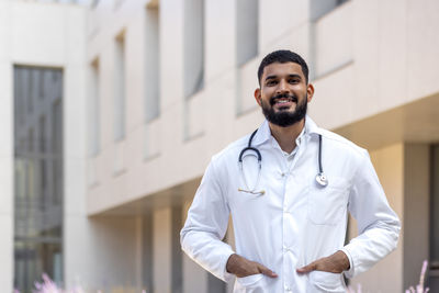 Portrait of male doctor standing in city